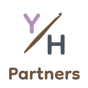 Yarn Over Hook Partners logo featuring a stylized Y and H connected by a crochet hook — representing collaboration, creativity, and partnership within the global crochet community.