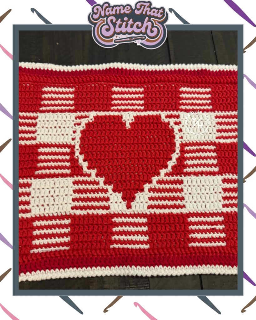 Crocheted red and white fabric featuring a large heart motif created with colorwork stitches, shown as part of the Name That Stitch daily crochet puzzle.