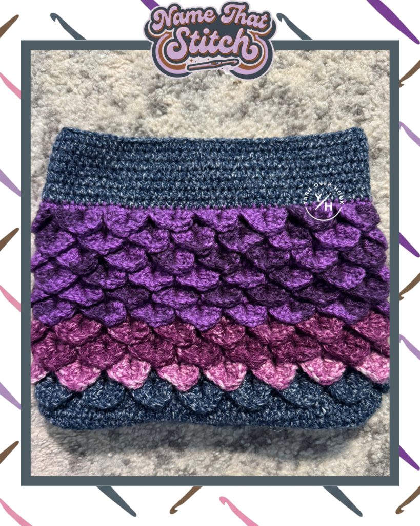 Close-up of a crocheted swatch featuring layered, textured stitch rows in shades of purple and blue, shown as part of the Name That Stitch daily crochet puzzle.