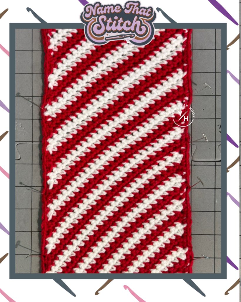 Close-up of a crocheted swatch with diagonal striped stitch rows in alternating red and white yarn, featured as part of the Name That Stitch daily crochet puzzle.