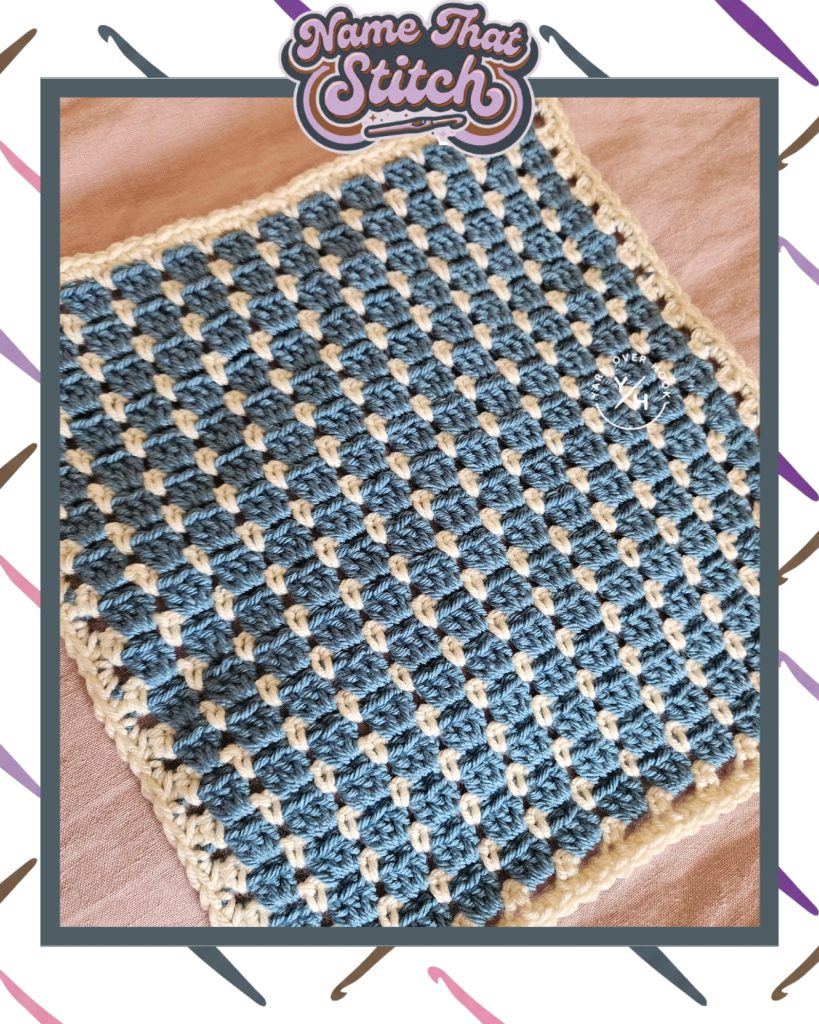 Close-up of a crocheted corner showing a textured stitch pattern in cream yarn with a contrasting blue, presented as part of the Name That Stitch daily crochet puzzle. View more at NameThatStitch.com