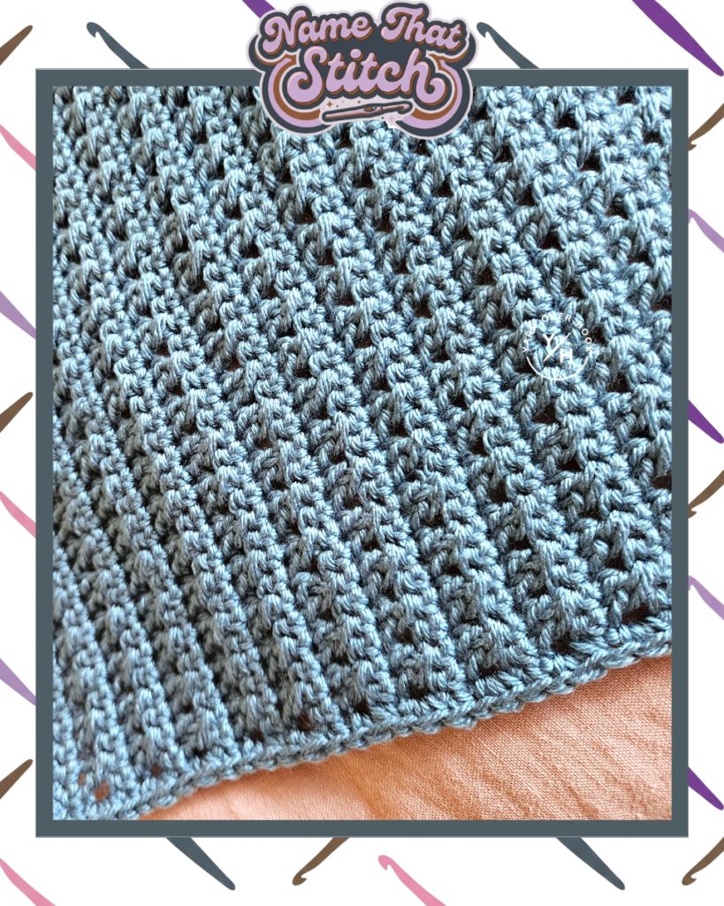 Close-up of a crocheted fabric showing a dense, repeating textured stitch pattern in light blue yarn, featured as part of the Name That Stitch daily crochet puzzle. View more at NameThatStitch.com