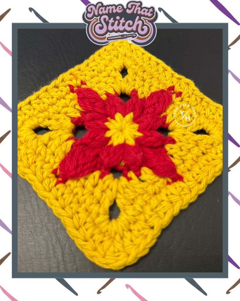Close-up of a crocheted granny-style square featuring a star-like center in red and yellow yarn with a textured yellow border, shown as part of the Name That Stitch daily crochet puzzle. View more at NameThatStitch.com