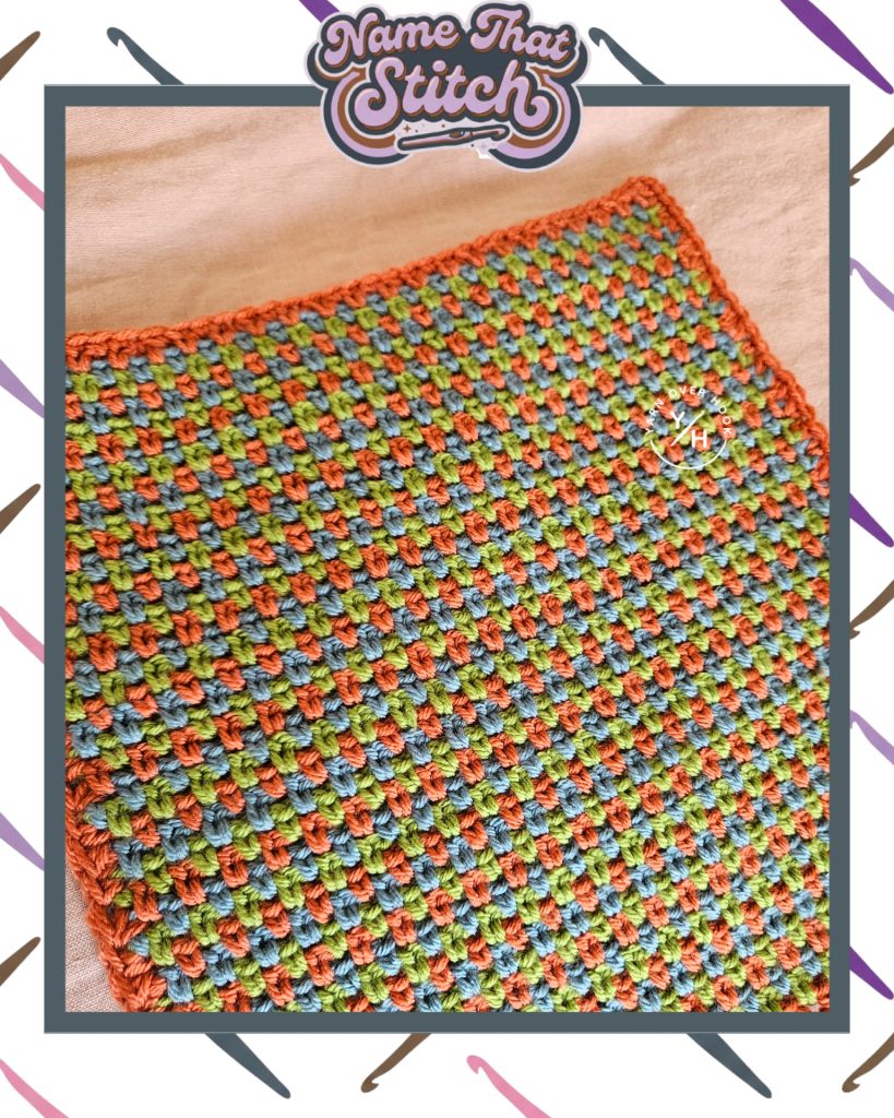 Close-up of a crocheted fabric displaying a tightly textured, repeating stitch pattern worked in alternating green, blue, and rust yarn, featured as part of the Name That Stitch daily crochet puzzle. View more at NameThatStitch.com