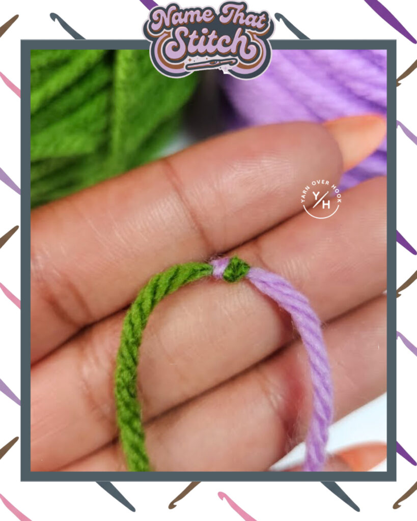 Close-up of two yarn strands—one green and one lavender—joined with a small knot, resting across fingers, shown as a “Name That Stitch” crochet puzzle image. View more at NameThatStitch.com