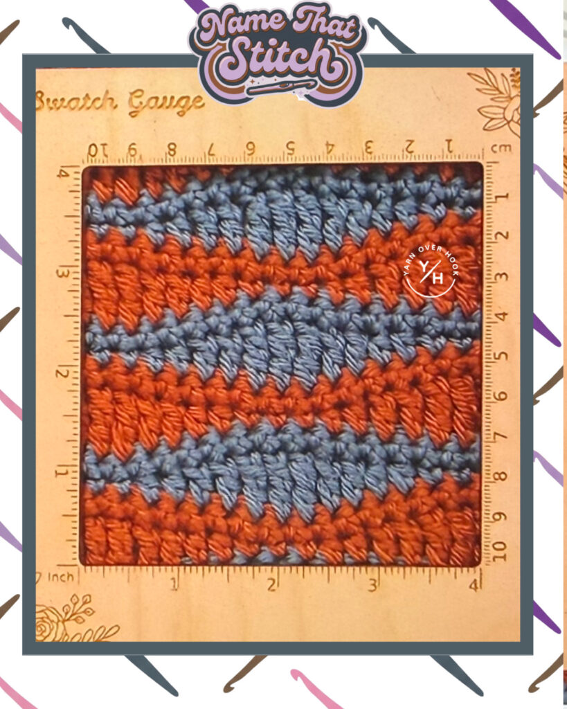 Close-up of a crochet swatch with alternating horizontal stripes in rust orange and dusty blue yarn, photographed inside a square gauge ruler showing inch and centimeter measurements for a Name That Stitch crochet puzzle. View more at NameThatStitch.com