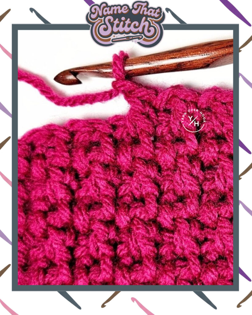 Close-up of a crocheted fabric displaying a repeating stitch pattern worked in pink yarn, with a wooden crochet hook and featured as part of the Name That Stitch daily crochet puzzle. View more at NameThatStitch.com