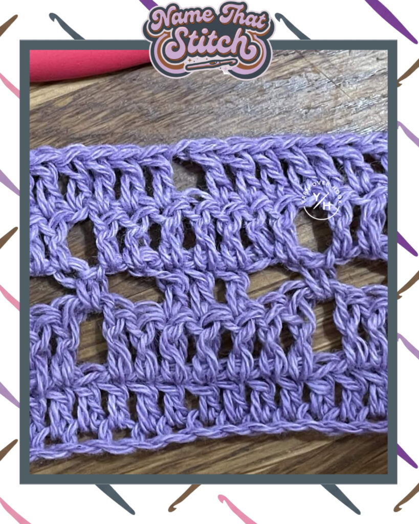Close-up of a crocheted fabric displaying a repeating stitch pattern worked in purple yarn and featured as part of the Name That Stitch daily crochet puzzle. View more at NameThatStitch.com