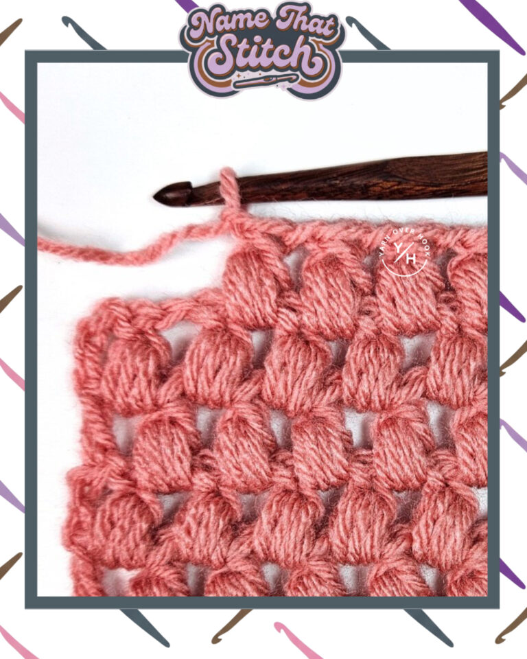 Close-up of a crocheted fabric displaying a repeating stitch pattern worked in pink colored yarn, with a wooden crochet hook and featured as part of the Name That Stitch daily crochet puzzle. View more at NameThatStitch.com