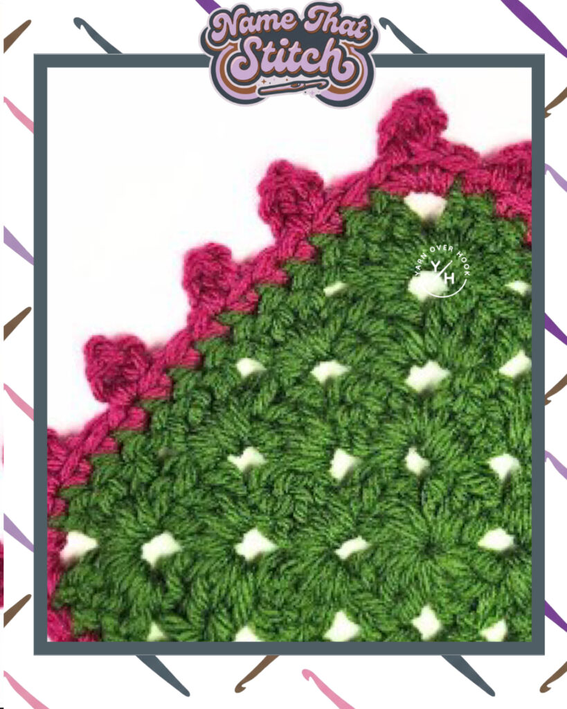 Close-up of a crocheted fabric displaying a repeating clustered stitch pattern worked in green yarn with a pink decorative edging, featured as part of the Name That Stitch daily crochet puzzle. View more at NameThatStitch.com
