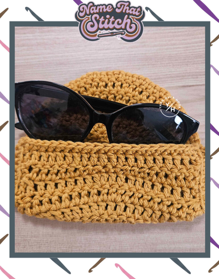 Close-up of a mustard yellow crocheted pouch holding black sunglasses, displaying a repeating openwork stitch pattern and featured as part of the Name That Stitch daily crochet puzzle. View more at NameThatStitch.com
