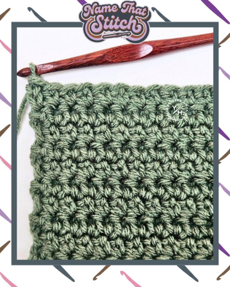 Close-up of a crocheted fabric displaying a repeating stitch pattern worked in green colored yarn, with a wooden crochet hook and featured as part of the Name That Stitch daily crochet puzzle. View more at NameThatStitch.com