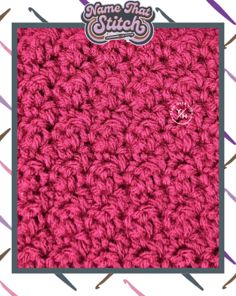 Close-up of a crocheted fabric displaying a repeating stitch pattern worked in maroon colored yarn, with a wooden crochet hook and featured as part of the Name That Stitch daily crochet puzzle. View more at NameThatStitch.com