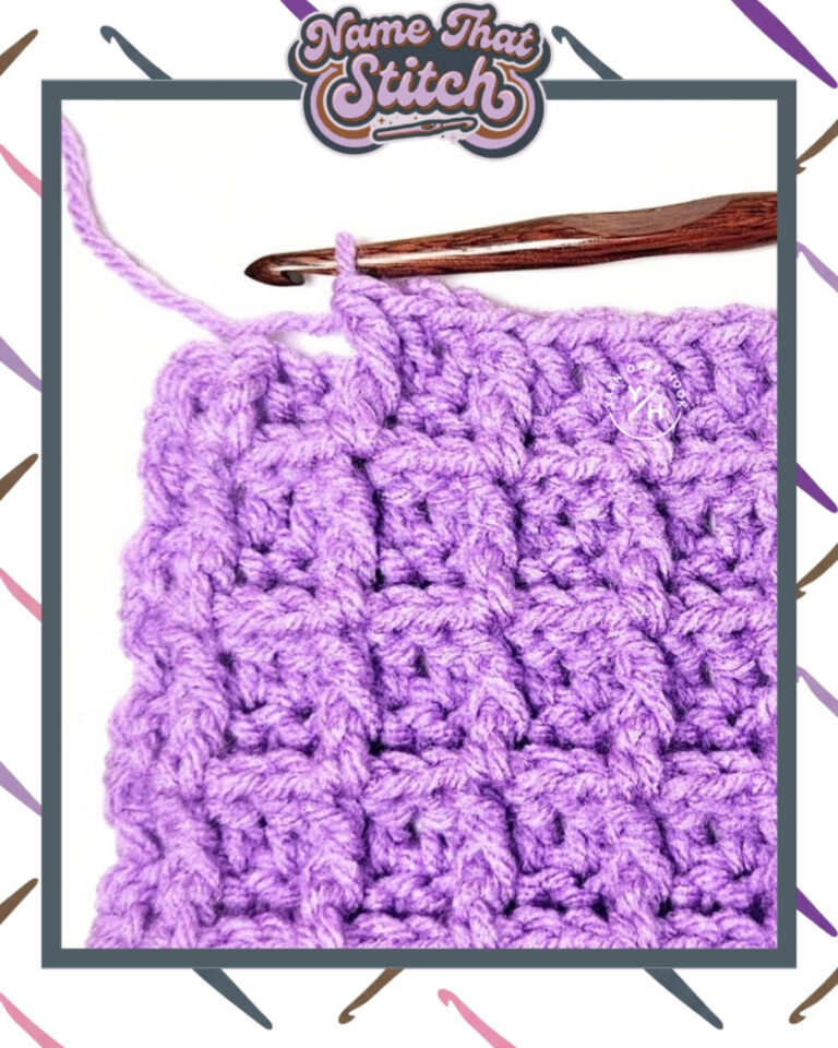 Close-up of a crocheted fabric displaying a repeating stitch pattern worked in purple colored yarn, with a wooden crochet hook and featured as part of the Name That Stitch daily crochet puzzle. View more at NameThatStitch.com